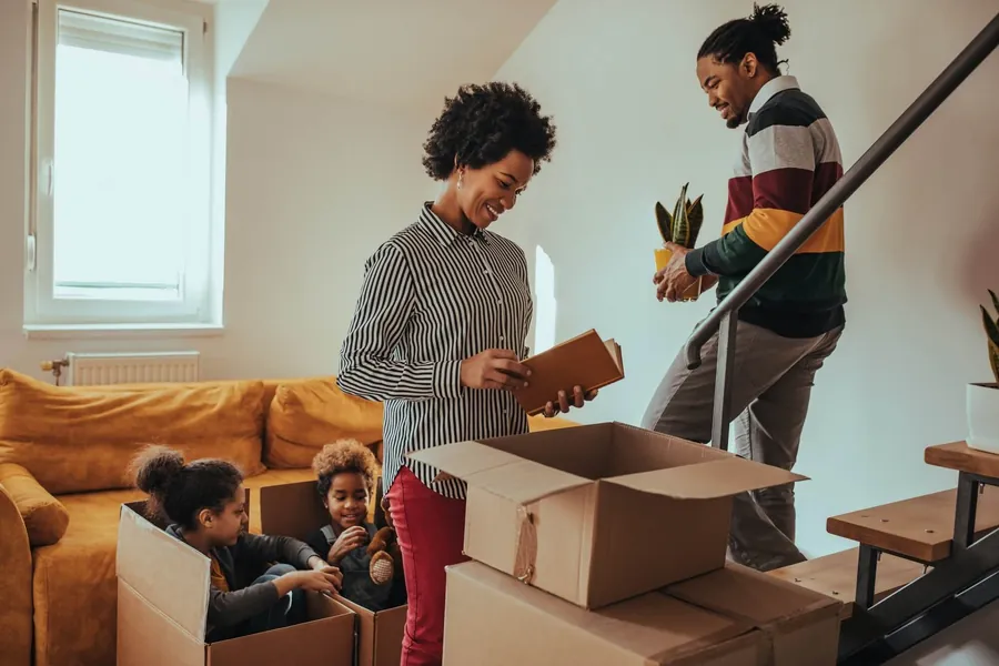 Family moving into a new home with boxes